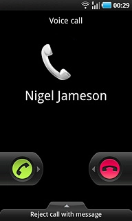 When you have an ongoing call, the new call is signalled by a sound.Press the accept call icon and drag the icon right.