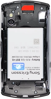 Take hold of the top of the battery and remove it.