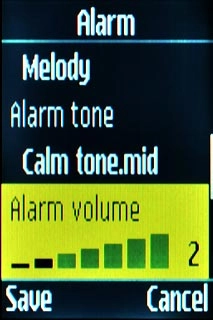 Scroll to Alarm volume and press Navigation key right to adjust the volume.