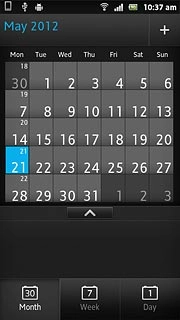 Go to month view (see above).Slide you finger right or left on the display to select the required month.