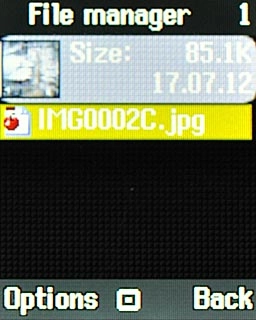 Go to the required folder.Highlight the required picture or the required video clip and press the Navigation key.