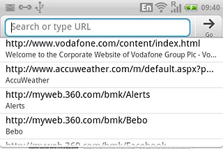 Press the address bar at the top of the display.