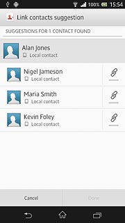 Press the merge icon next to the required contacts.
