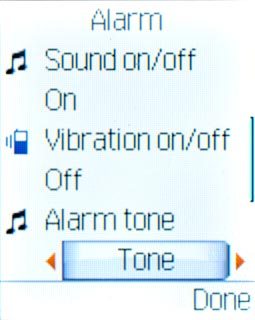 Highlight the field below Alarm tone and press Navigation key right or Navigation key left to select Tone or FM radio.