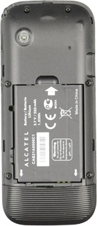Take hold of the top of the battery and remove it.