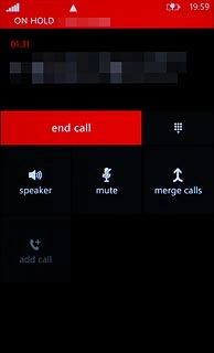 Make sure the call you want to end is active.Press end call.The active call is ended and the call on hold is activated.